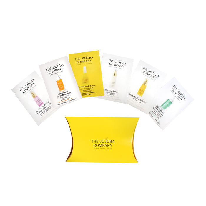 Set of The Jojoba Company skincare product samples on a white background