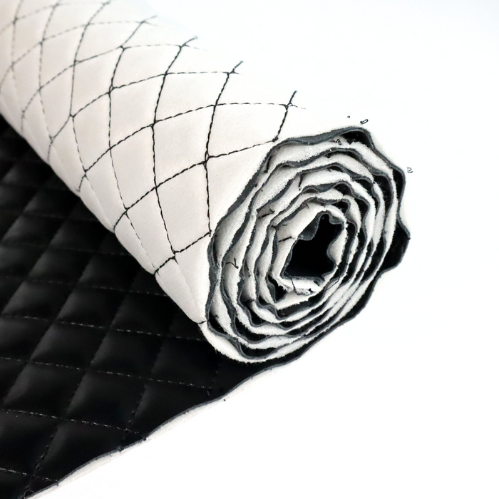 This pre-quilted vinyl is in a solid black. This photo is of the vinyl rolled up.