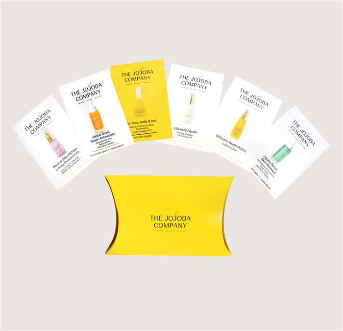 Set of The Jojoba Company product packaging on a light gray background