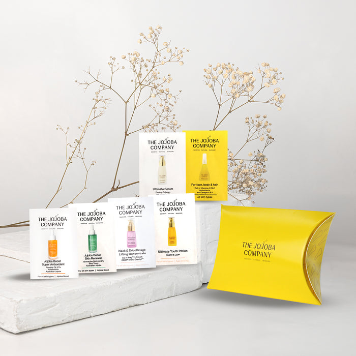 The Jojoba Company product packaging on a light gray background with decorative branches.