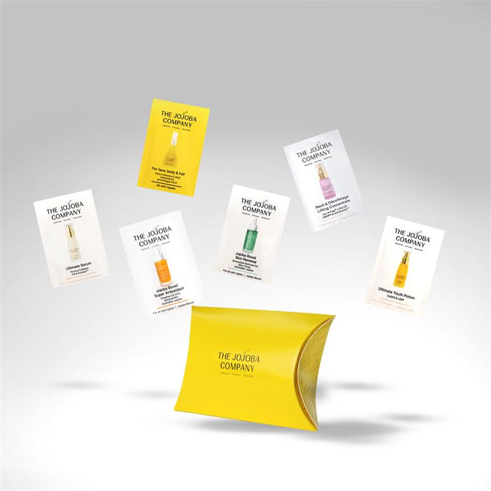 Collection of The Jojoba Company product packaging on a gray background