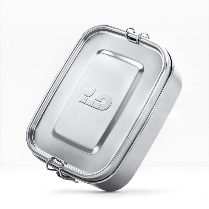 Metallic rectangular bambaw lunch box container with a lid on a white background