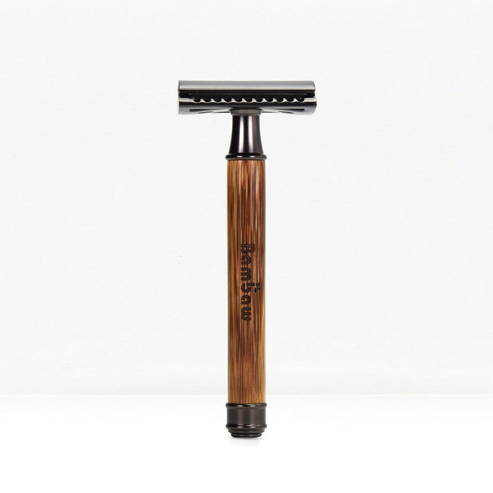 Bamboo safety razor with darker wooden handle and chrome head standing upright on a white background