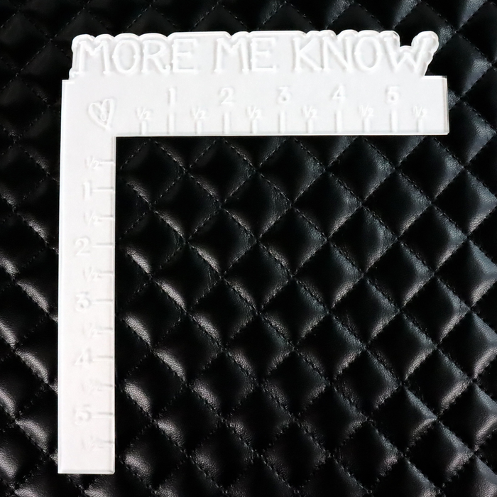 This pre-quilted vinyl is in a solid black. This photo shows a ruler on the fabric for size.