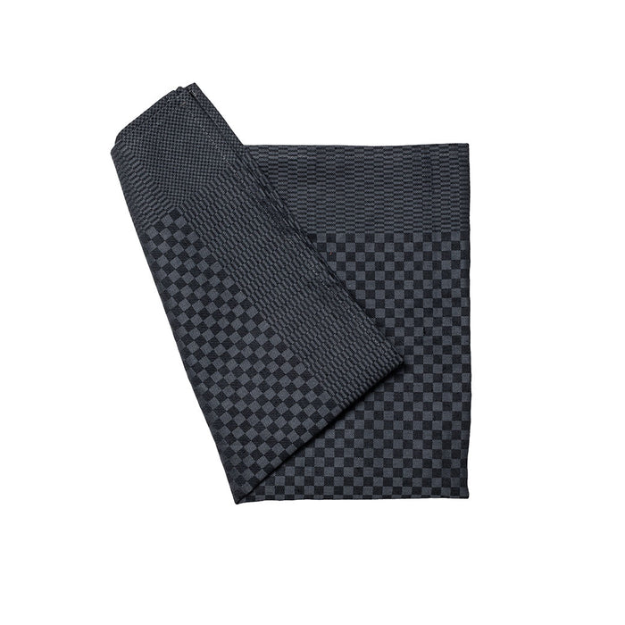 Folded black and gray checkered towel on a white background