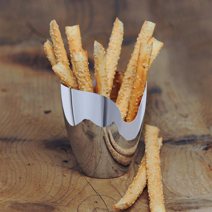 Polished metallic holder with bread straws on a wooden surface