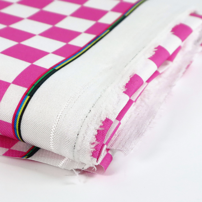 This printed WPC-Lite features a checkered pattern with deep pink and white squares. This photo shows the fabric folded.