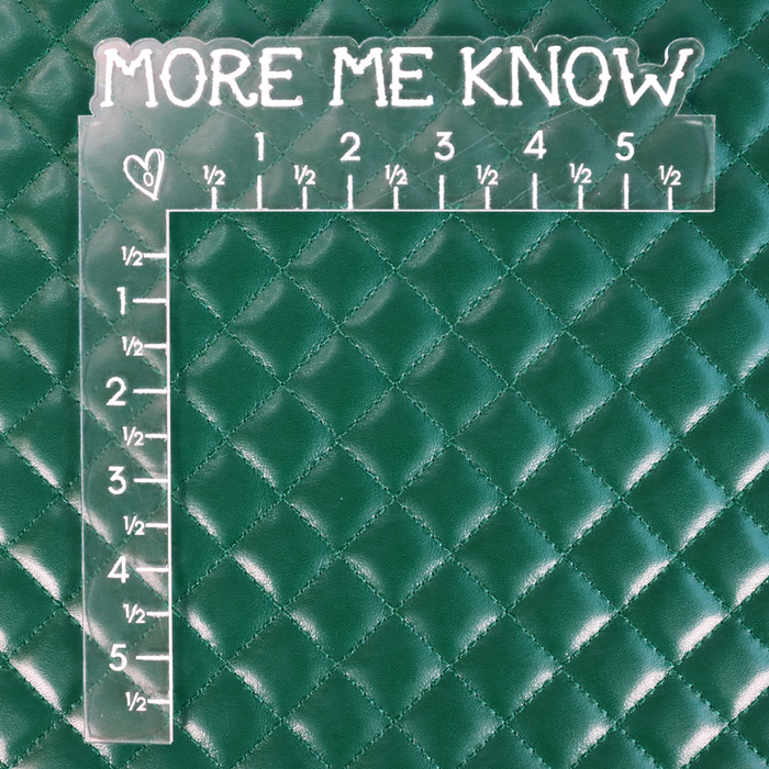 This pre-quilted vinyl is a saturated and deep shade of green. This photo shows a ruler on  the fabric cool