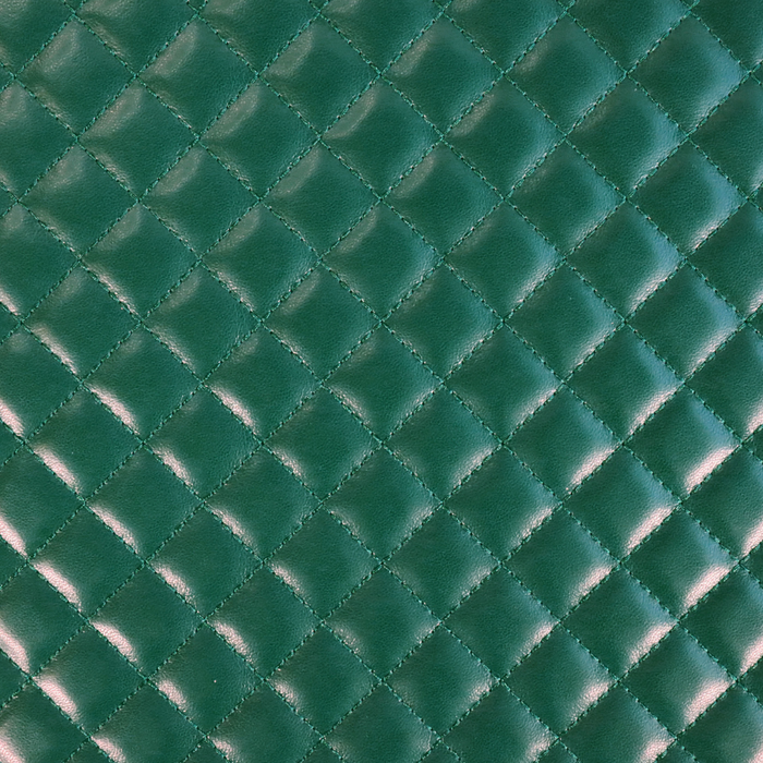 This pre-quilted vinyl is a saturated and deep shade of green.