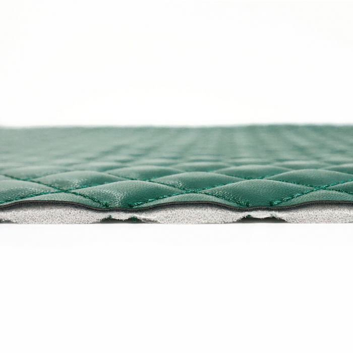 This pre-quilted vinyl is a saturated and deep shade of green.