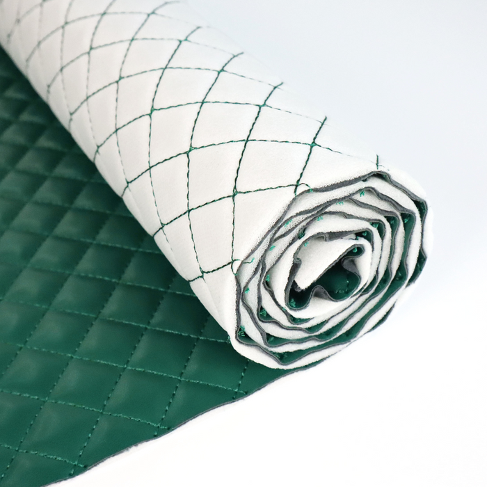 This pre-quilted vinyl is a saturated and deep shade of green. This photo is of the vinyl rolled up.