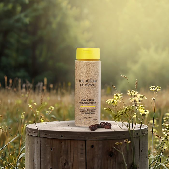 Bottle of The Joujoba Company product on a wooden stump with a natural background