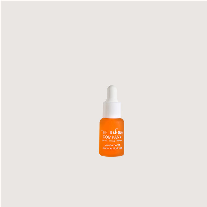 Jojoba Boost Super Antioxidant Orange bottle with white cap on a light gray background