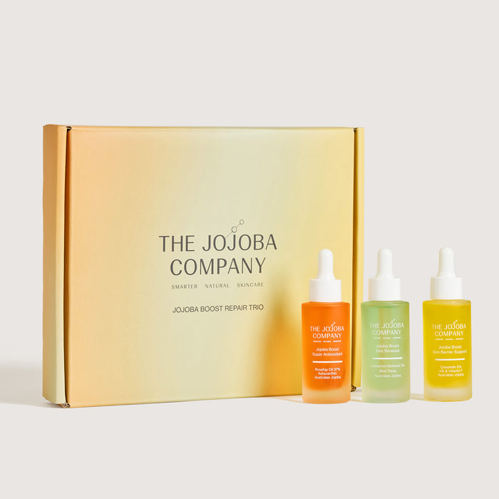 The Jojoba Company skincare set with three bottles in front of a branded box on a white background