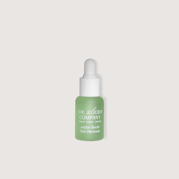 Skincare dropper bottle with 'The Jojoba Company' branding on a light gray background