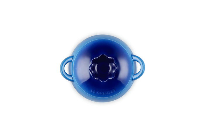 Top view of blue ceramic pot with lid that looks like a blueberry on a white background