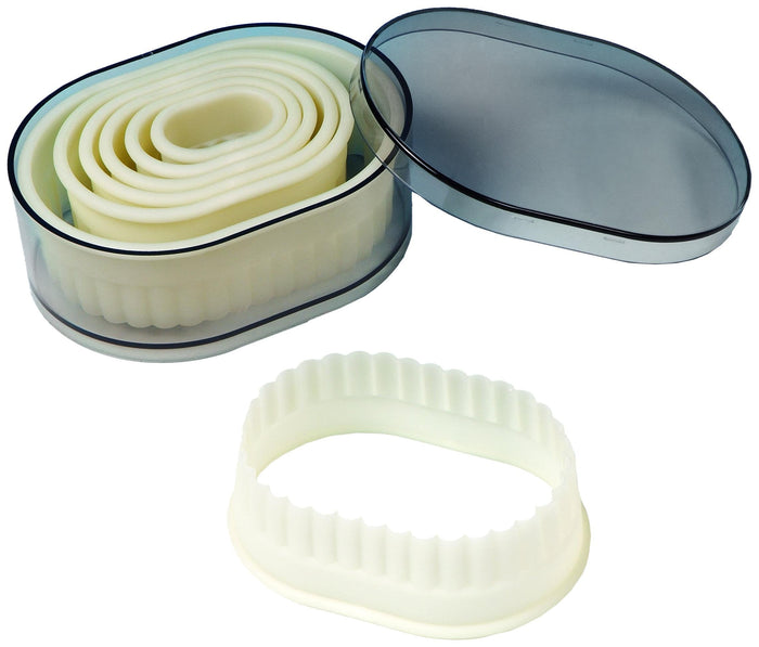 Set of white plastic cookie cutters with a storage container on a white background