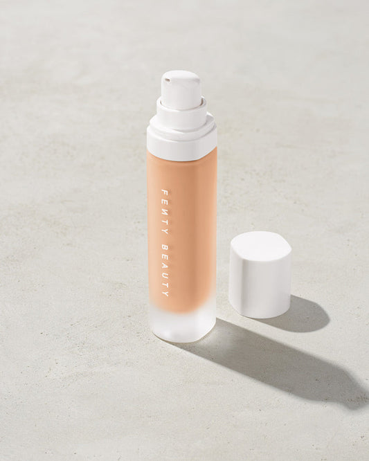 open bottle of Fenty Beauty Pro Filt'r Soft Matte Longwear Foundation with pump dispenser in shade #170 on concrete background