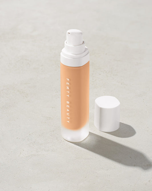 open bottle of Fenty Beauty Pro Filt'r Soft Matte Longwear Foundation with pump dispenser in shade #230 on concrete background