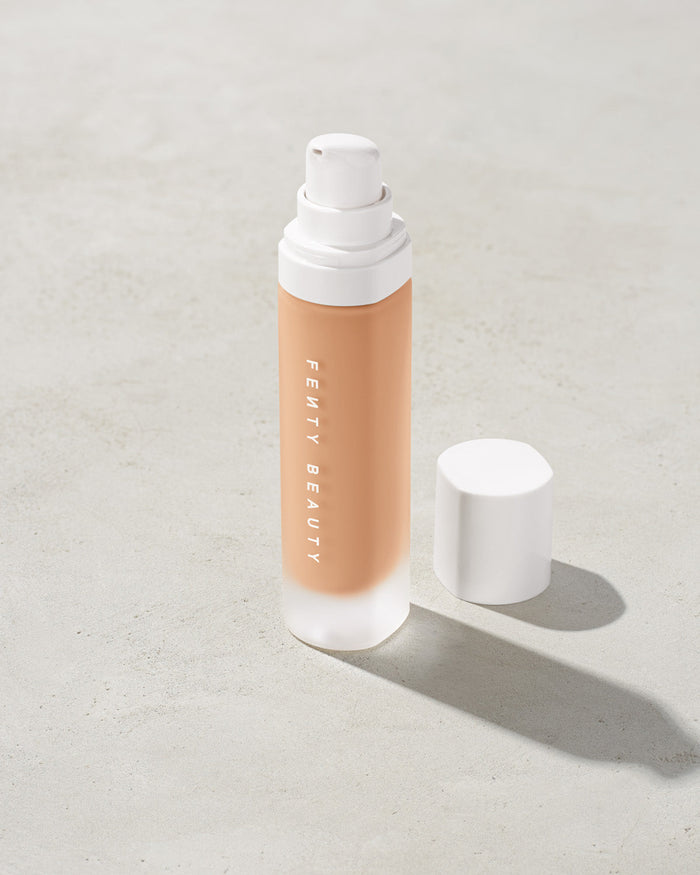 open bottle of Fenty Beauty Pro Filt'r Soft Matte Longwear Foundation with pump dispenser in shade #260 on concrete background