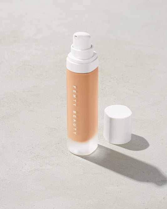 open bottle of Fenty Beauty Pro Filt'r Soft Matte Longwear Foundation with pump dispenser in shade #260 on concrete background
