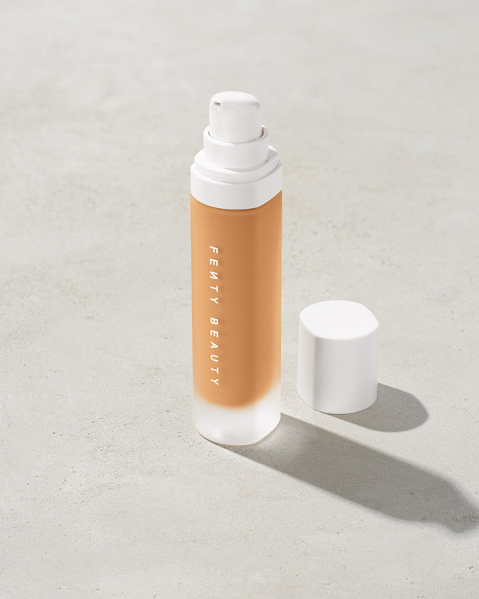 open bottle of Fenty Beauty Pro Filt'r Soft Matte Longwear Foundation with pump dispenser in shade #280 on concrete background