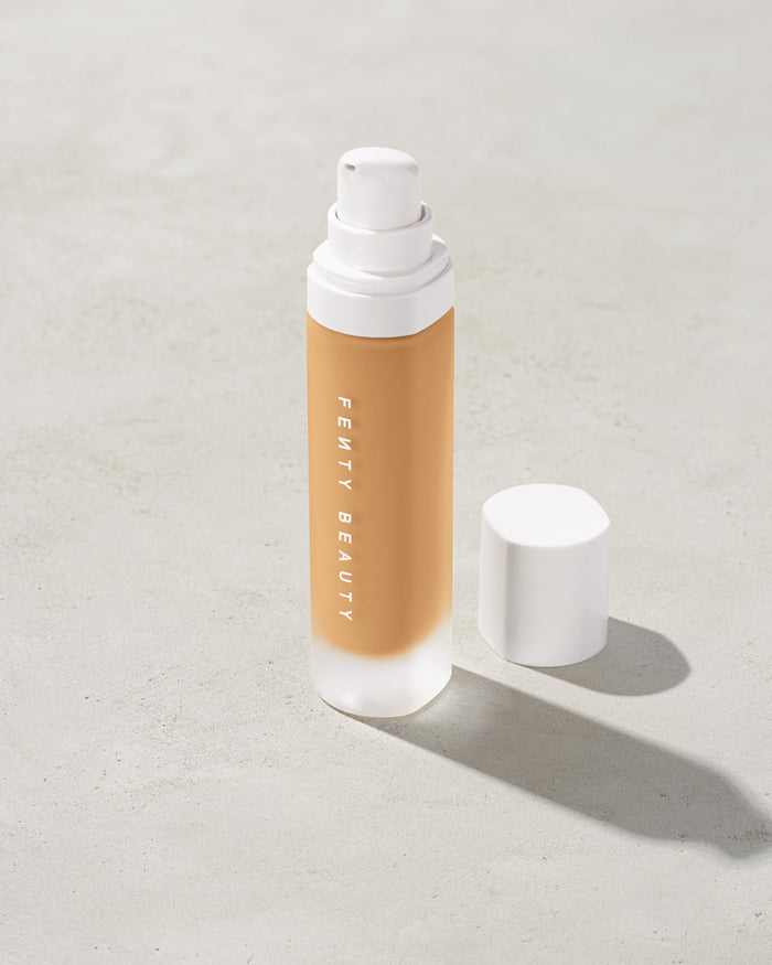 open bottle of Fenty Beauty Pro Filt'r Soft Matte Longwear Foundation with pump dispenser in shade #290 on concrete background