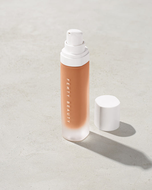 open bottle of Fenty Beauty Pro Filt'r Soft Matte Longwear Foundation with pump dispenser in shade 370 on concrete background