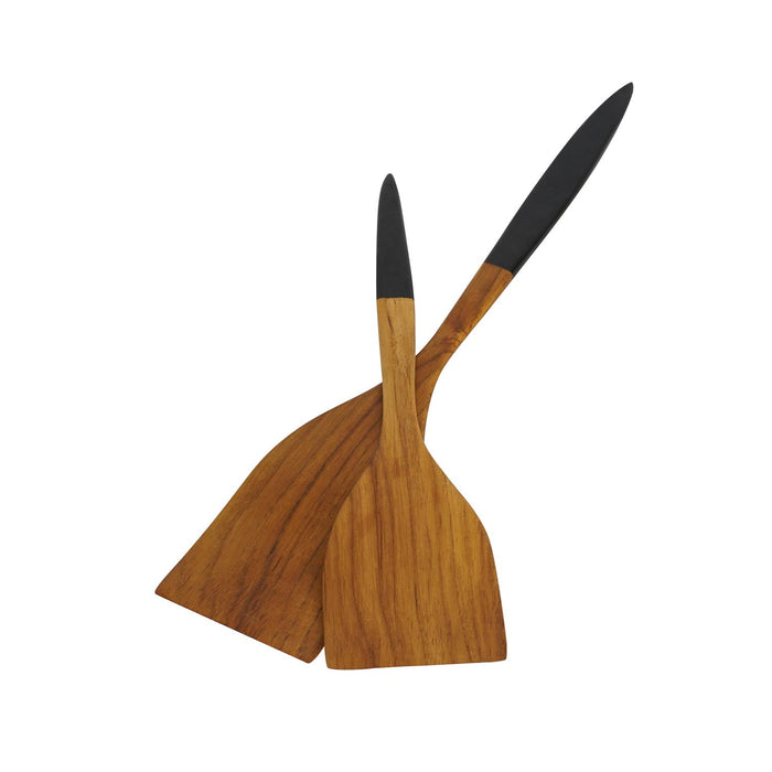 2 Rico & Plato resto teak spatula with black handle crisscross each other displayed on a white background