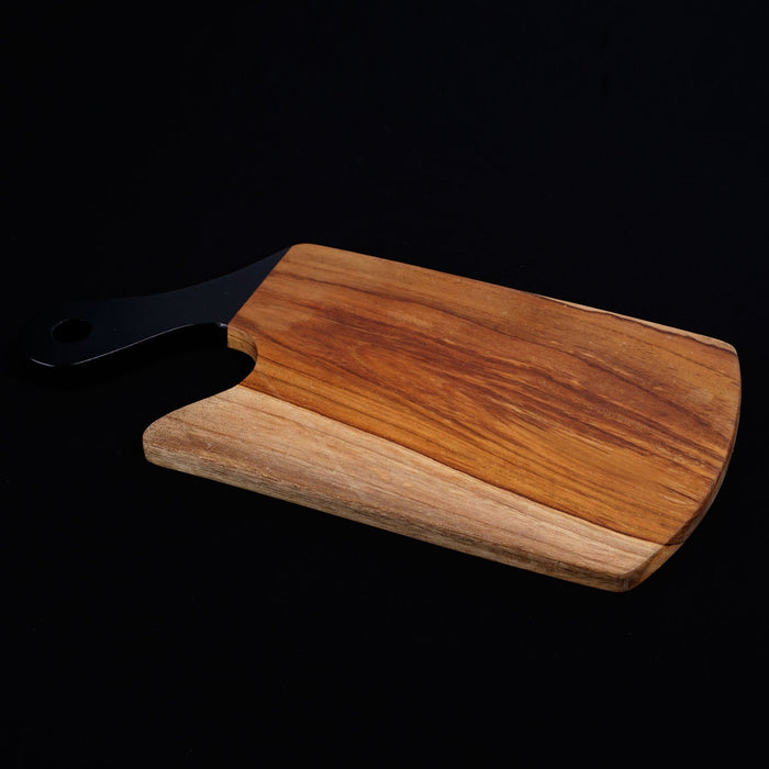 Teak cutting board with black handle displayed on a black background