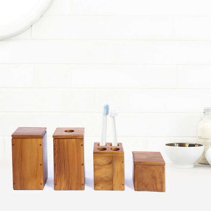 Set of four wooden bathroom containers with different sizes displayed on a white bathroom counter