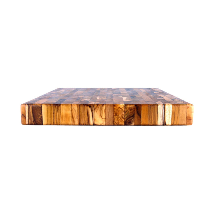 Side view of an end grain cutting board on a white background