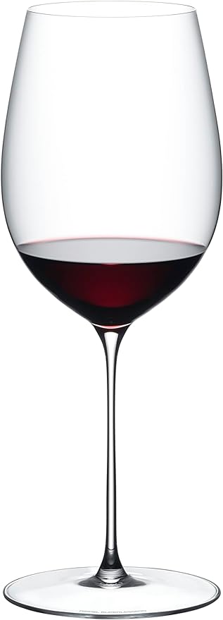 Riedel superleggero Bordeaux grand wine glass with red wine inside on a white background