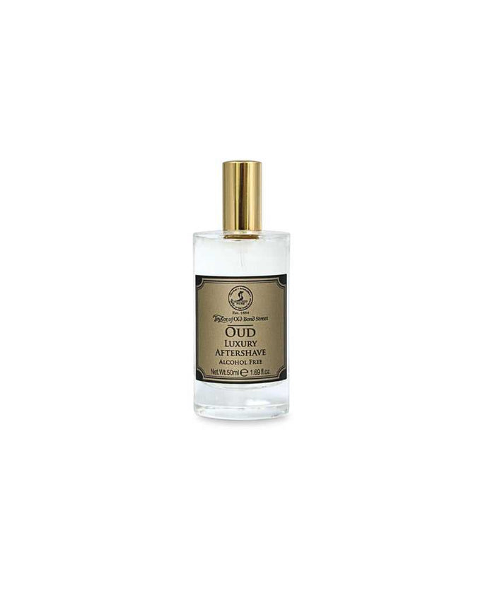 Close-up of Taylor of Old Bond Street Oud Aftershave Lotion bottle with gold cap, alcohol-free grooming product
