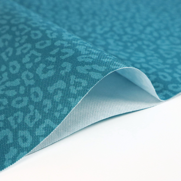 This printed WPC-Lite has a repeating light teal leopard print design with a deep saturated teal background.