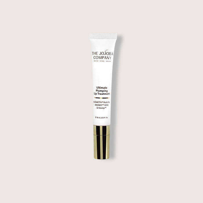 Lip treatment tube from The Jojoba Company on a light gray background