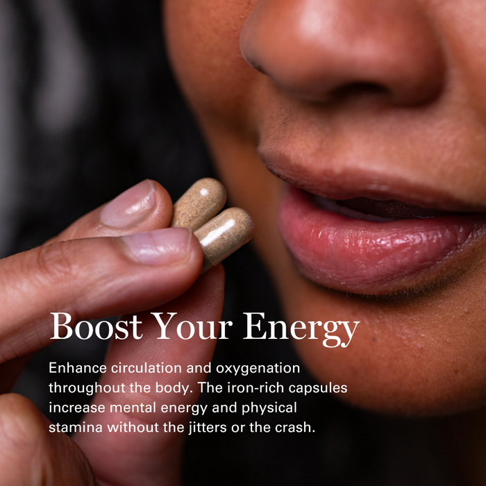 Person holding iron-rich herbal capsules with text promoting energy boost and improved circulation.