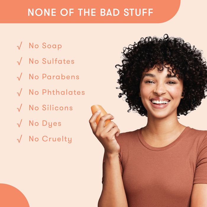 Model holding HiBAR conditioner bar in her hand with a list of bad things that are not in HiBAR. No soap. No sulfates. No parabens. No phthalates. No silicons. No dyes. No cruelty.