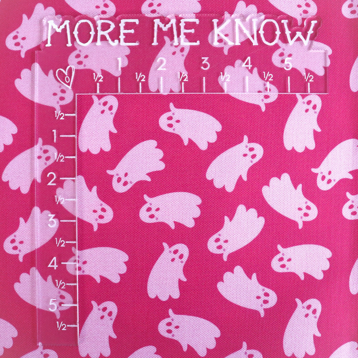 This printed WPC-Lite has ghosts that are featured in light pink on top of a deeper pink background. This photo shows an L shaped ruler for scale.