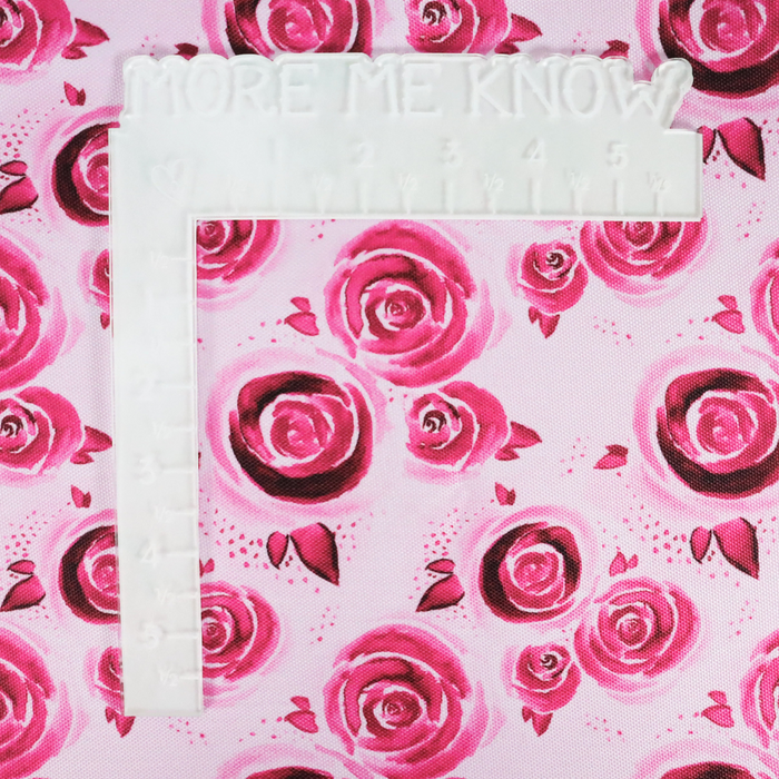 This printed WPC has a watercolor rose design in the magenta. This photo shows a white L shaped ruler for scale.
