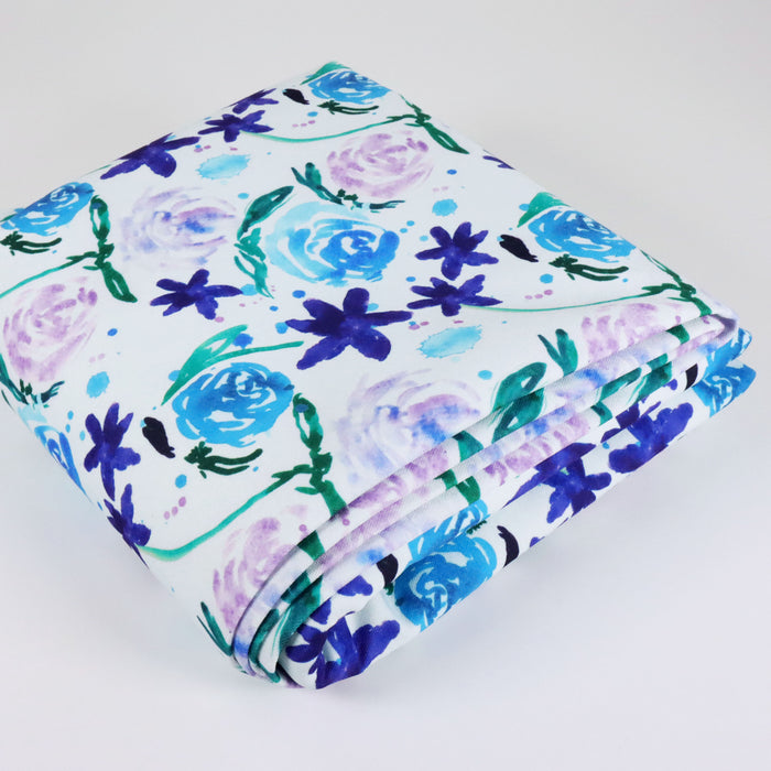 This WPCotton has roses and flowers in shades of blue, purple and green. This photo is of the fabric folded.